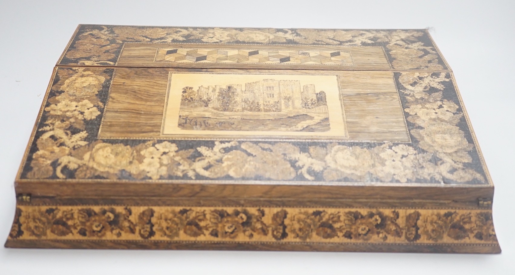 A Victorian Tunbridge ware rosewood writing slope, decorated with a tesserae mosaic view of Hever Castle, 39cm wide, with mosaic inlaid interior and covers to the glass inkwells.